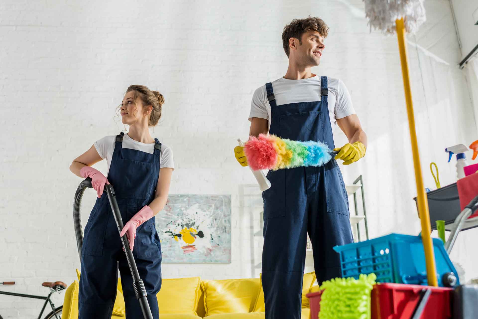 star-cleaning-group-selective-focus-happy-cleaners-uniform-looking-away-cleaning-trolley-modern